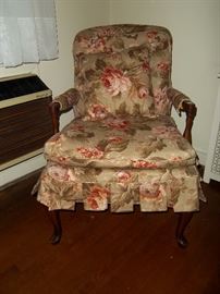 Upholstered chair with wood feet and arms. Matching pillow included.