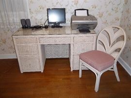 wicker desk with matching chair and glass top. Like new! Pull out drawer for keyboard, and two filing cabinet drawers. Printer, monitor and speakers also for sale.