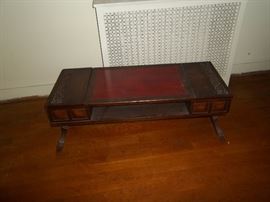 1940's hand carved with leather top coffee table.