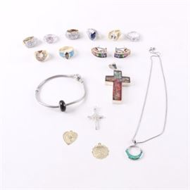 Selection of Sterling Silver Jewelry Including Pandora: A selection of sterling silver jewelry including a Pandora bracelet. This selection is comprised of fifteen pieces including a necklace, bracelet, pendants, earrings and rings. Featured materials include synthetic opal, cubic zirconia, coated cubic zirconia and glass. Featured pieces include a Pandora bracelet with a charm, both hallmarked “925 ALE Pandora,” a large colorful crucifix cross, as well as uniquely styled and colorful rings and earrings. Each piece is hallmarked or tested as sterling silver with the exception of one gold filled pendant. The total sterling silver weight, inclusive of all materials, is 3.260 ozt.