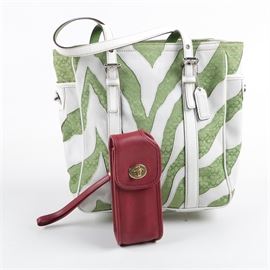 Coach Zebra Carryall Tote and Leather Cell Phone Pouch: A Coach Zebra Carry all tote and a leather cell phone case. The carryall features a green initial monogrammed jacquard accented with stylized white leather zebra stripes. Dual white leather adjustable shoulder straps, side turnlock pockets and a zippered top closure. The interior has a yellow-green grosgrain lining with slip pockets and a zippered pocket with a creed patch and serial number A060-2555. A red leather cell phone case with a gold-tone turn lock and red leather wrist strap completes the listing.