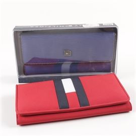 Women's Tommy Hilfiger Wallets: A pair of women’s Tommy Hilfiger wallets. Included is a textured blue leather envelope wallet with a coin pocket to the back, a black lining with dual ID slots, card slots and a checkbook slip. A red fabric wallet with the Hilfiger “H” to the full front flap and a red lining completes the listing.