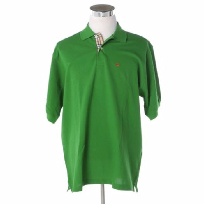 Men's Burberry Green Polo Shirt: A men’s Burberry polo shirt. This cotton shirt is green in color and features a collared neckline with the classic Burberry plaid print pattern to the interior and an embroidered Burberry emblem to the chest. It is labeled to the interior, “Burberry London, XL, made in Great Britain, 100% cotton”.