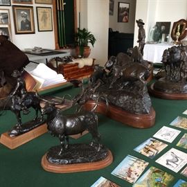 Bronzes & postcards on the pool table.
