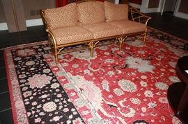 12 by 18 Antique reproduction rug.  McGuire  Rattan Gold Leaf Sofa. 