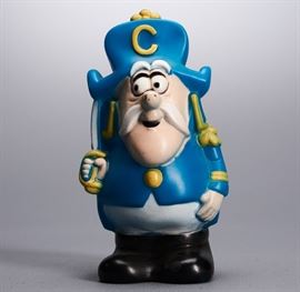 Offered is a 1970s Cap'n Crunch coin bank. This advertising character stands 7" tall. The stopper is included. There is some chipping to the paint and fading to the color. Please see the photos for more details.