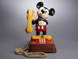 Offered is a vintage, 1976 Disney Mickey Mouse phone. The phone has white push buttons. It is made in the USA and stands approximately 15" tall. The white cord is included but needs cleaning. There are some light scratches to the paint.This item has not been tested. Please see photos for more details.
