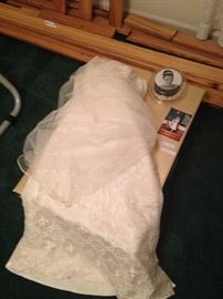 Ivory lace T-length wedding dress, size 8 off the rack but with some alterations to waist, hips, and bust. And by bust, they sewed one in. Dress has been preserved in keepsake box appropriately along with veil and crown. All in perfect condition. 