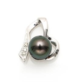 18K White Gold Cultured Tahitian Pearl and Diamond Slide Pendant: An 18K white gold cultured Tahitian pearl and diamond slide pendant. This pendant features a center cultured Tahitian pearl in an open, asymmetrical ribbon design pendant with round brilliant cut diamond accents.