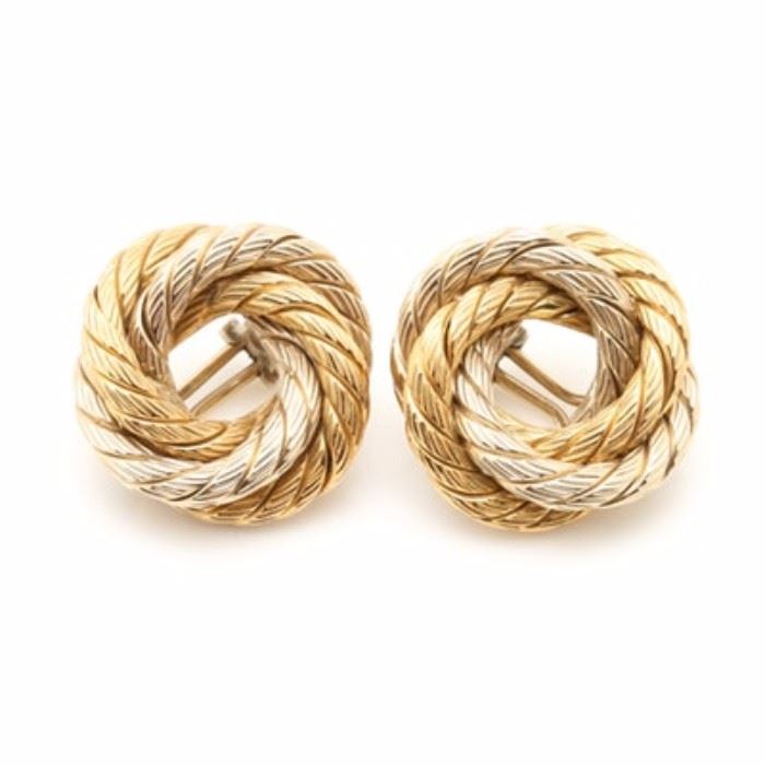 Carlo Weingrill 18K Yellow and White Gold Open Knot Clip On Earrings: A pair of Carlo Weingrill 18K yellow and white gold open knot clip on earrings. This pair of earrings features an open knot motif, which has two twisted textured cables intertwined in yellow and white gold.
