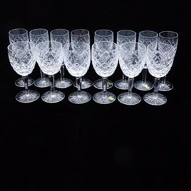 Collection of Waterford Crystal Stemware: A collection of fourteen pieces of Waterford Crystal Comeragh stemware. The collection includes eight champagne flutes and six water goblets Each glass features cut diamond design to the body, a faceted stem and round foot with cut starburst design. The glasses are marked “Waterford” to the underside.