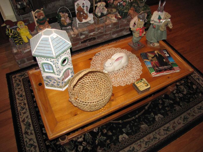 The coffee table, a basket, rabbit figurines, and some other items.
