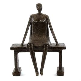 Mixed Media Sculpture by Allen Wynn "Woman Watching": A mixed media sculpture by contemporary artist Allen Wynn, titled Woman Watching. The sculpture depicts a female figure sat on a bench. Her head is tilted up and to the side, fixed on something in the distance, and her long, thin arms are stretched out beside her in a gesture of calm composure. It is marked to the seat with a circled, red “W”. Allen Wynn grew up on a farm in Southern Ohio and is a self-taught artist, working mostly in mixed media and metal sculpture.