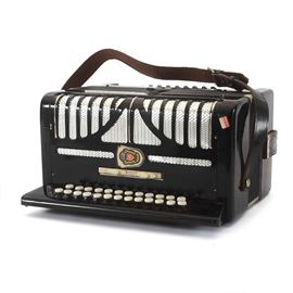 Russian Button Bayan Accordion: An early-mid 20th C. Russian button bayan accordion. The button accordion is housed in the original hard-sided case with instructional literature in Cyrillic script.