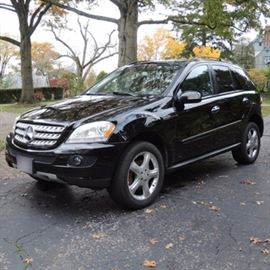 2008 Mercedes-Benz ML350 SUV: A 2008 Mercedes-Benz ML350 SUV; VIN is 4JGBB86EX8A377277 and odometer reads 124,437. This 4-door, 5-passenger M-Series crossover SUV features a 3.5L 6-cylinder engine and a 7-speed automatic transmission. It features the 4MATIC four-wheel drive system designed by Mercedes-Benz to increase traction in slippery conditions. This vehicle is featured with a black exterior, a black leather interior with lacquered burl wood trim, an automatic rear lift, an electric sunroof, electric adjustable seats, a 60/40 split folding rear seat, five-spoke wheels, 19” tires with a stored spare, a COMAND navigation system, a satellite radio, a CD player, a Harman/Kardon speaker system, a Bluetooth adapter in the center console, a Valley tow hitch, and a Husky cargo liner. It also features an after-market Bilstein suspension system. Original owner’s manuals and two keys are included.