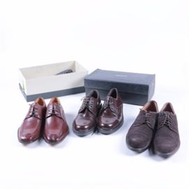 Men's Alfani, Bachrach and Bass Dress Shoes: A selection of Men’s Alfani, Bachrach and Bass dress shoes. The three pairs include dark brown leather dress oxfords by Alfani with capped stitching accents; a pair of Bachrach warm chestnut hued brown leather oxfords with split toe stitching and a pair of Bass oxfords in brown suede with capped toes and leather piping trim.