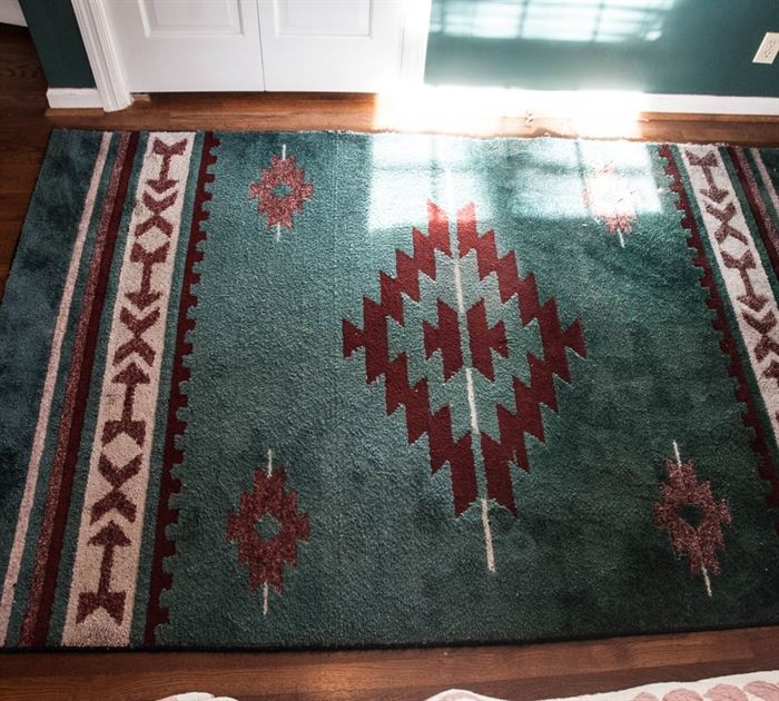 Machine Made Burlington Industries Southwestern-Style Area Rug: A machine made Southwestern-style accent rug. This rug features a teal blue background with burgundy and white pattern. Tagged to reverse “Burlington Industries.”