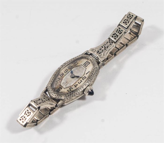Vintage Women's Wristwatch: A women’s 14K white gold wristwatch. Art Deco styling through and a floral motif to center.