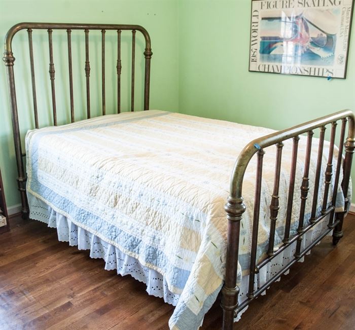 Antique Brass Bed Frame: An antique brass, full-size bed frame, featuring a headboard and footboard with a curved tubular frame and vertical tubular spindles.