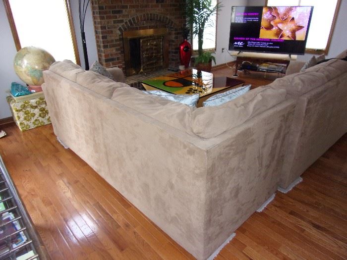 Microsuede sectional excellent condition. Custom made art piece coffee table. Unique conversational piece! TV and stand not for sale.