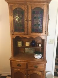 Oak kitchen cupboard with stained glass doors