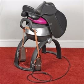 Kincade All Purpose English Saddle and iGallop: A Kincade English riding saddle. This black synthetic all purpose saddle shows a high rounded cantle and forward saddle flaps with padded supports. Also included is an Osim iGallop exercise machine, used to simulate the movements of a horse for improving balance.