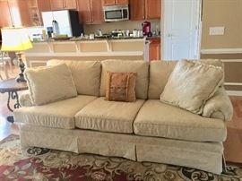 Beautiful ivory 3 cushioned sofa with matching love seat.