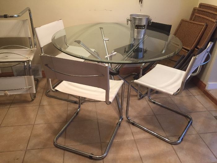  Mid century glass top stainless steel base table and 6 chairs (  leather ) $500