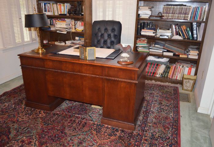 Hekman Office desk; leather executive's office chair; books