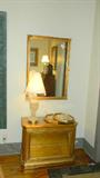 Goldleaf lighted display cabinet, gold beveled mirror, crystal lamps, prints