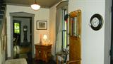 nail kegs, oak hall tree, oak entry chest, footstool, brass umbrella stand, jadite lamp, prints
