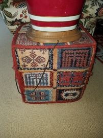 A Hassock/Ottoman with Afghan carpet covering 