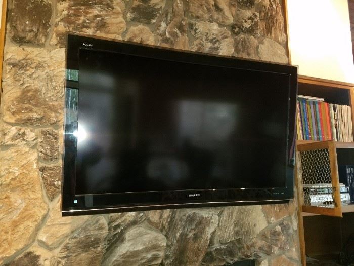 Very Large Sharp Flat Screen TV - This flat screen can be hung on the wall but it also has the stand for it!