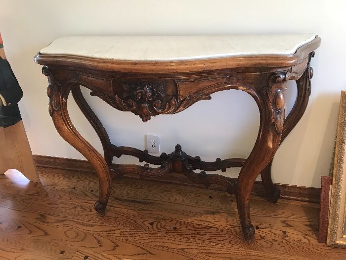 Marble top console table with detailed high relief carvings and cabriole legs