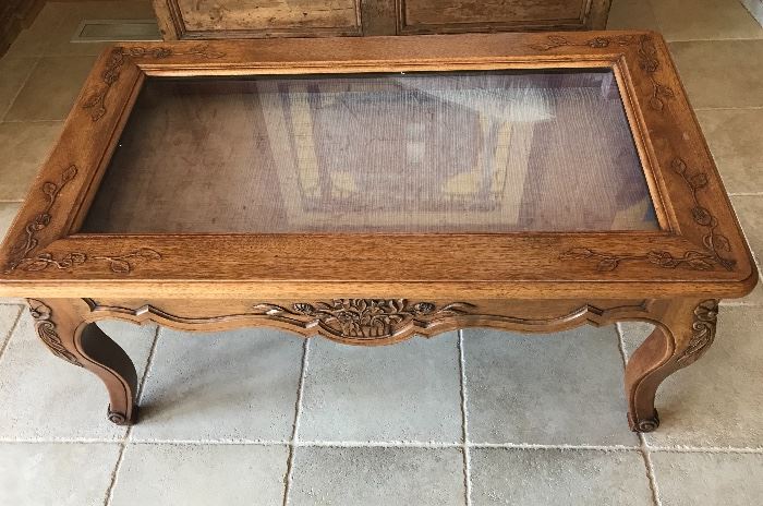 Carved coffee table with shadow box top for displaying collections