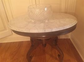 several marble top tables and gorgeous crystal