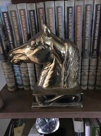 One of a pair of large brass horse head bookends