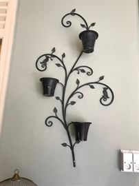 One of a pair of large wrought iron on-the-wall hanging planters