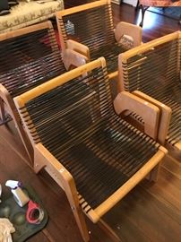 Set of four mid-century modern chairs with interesting webbing.  No cushions.