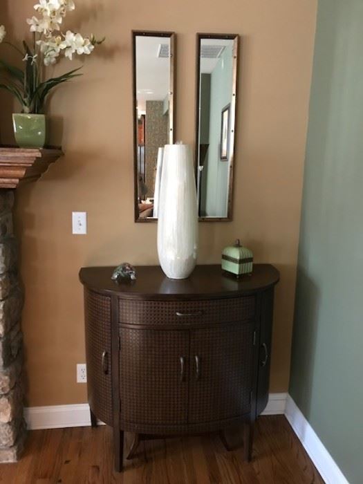 one of a pair of demilune accent cabinets