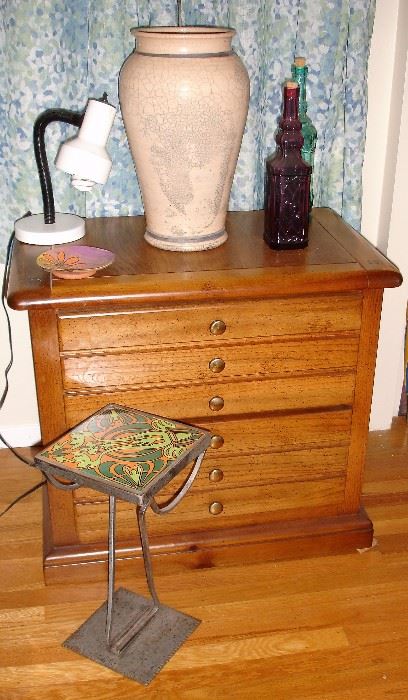Small chest with tile bed stand, vase and bottles