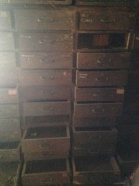 Approximately 40 drawers in this wood cabinet.