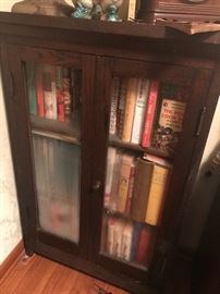 Double (glass) door display cabinet. And a variety of cookbooks 
