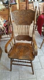 One of 2 captains chairs for oak clawfoot table