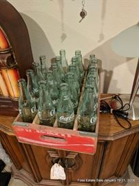Assorted Coca Cola Bottles and Carrying Rack