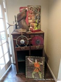 Assorted decroative items including a vintage wooden deer head, boat steering wheel and related decorative items
