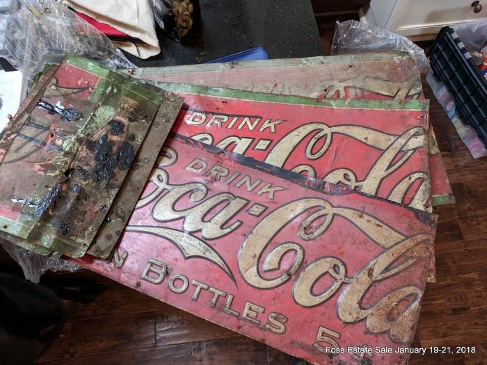 Vintage coke signs which appear to have been cut and used as roofing shingles.