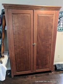 Raised-panel armoire with two doors.