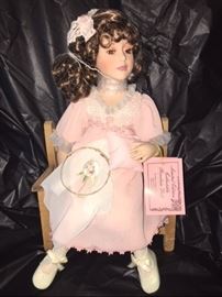 porcelain collectable doll with chair and certificate of authentication