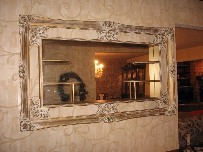 Ornate framed mirror with shelves